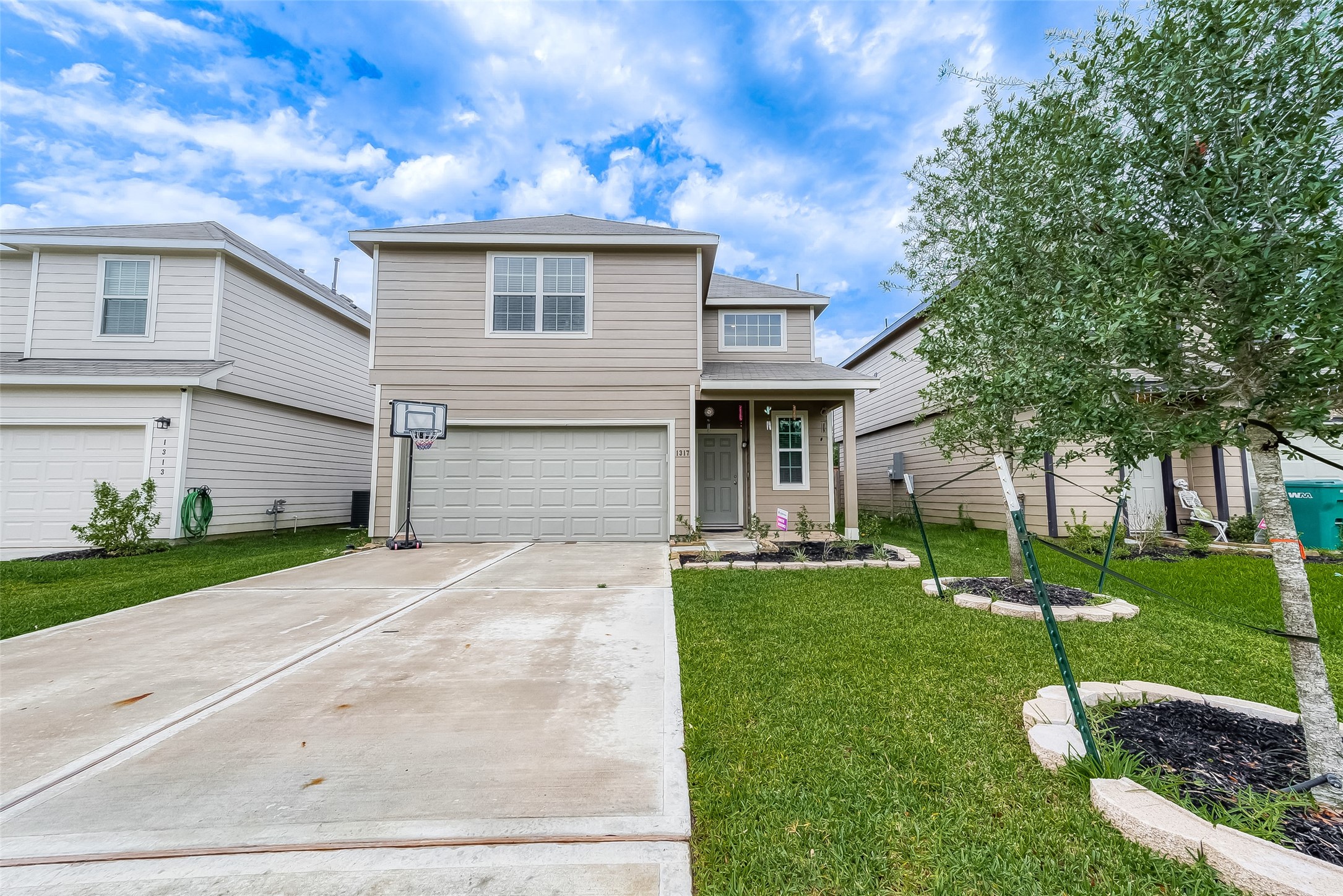 1317 Mount Bassie Trail Conroe, TX 77301 - Photo 2 of 50 a front view of a house with a yard and garage