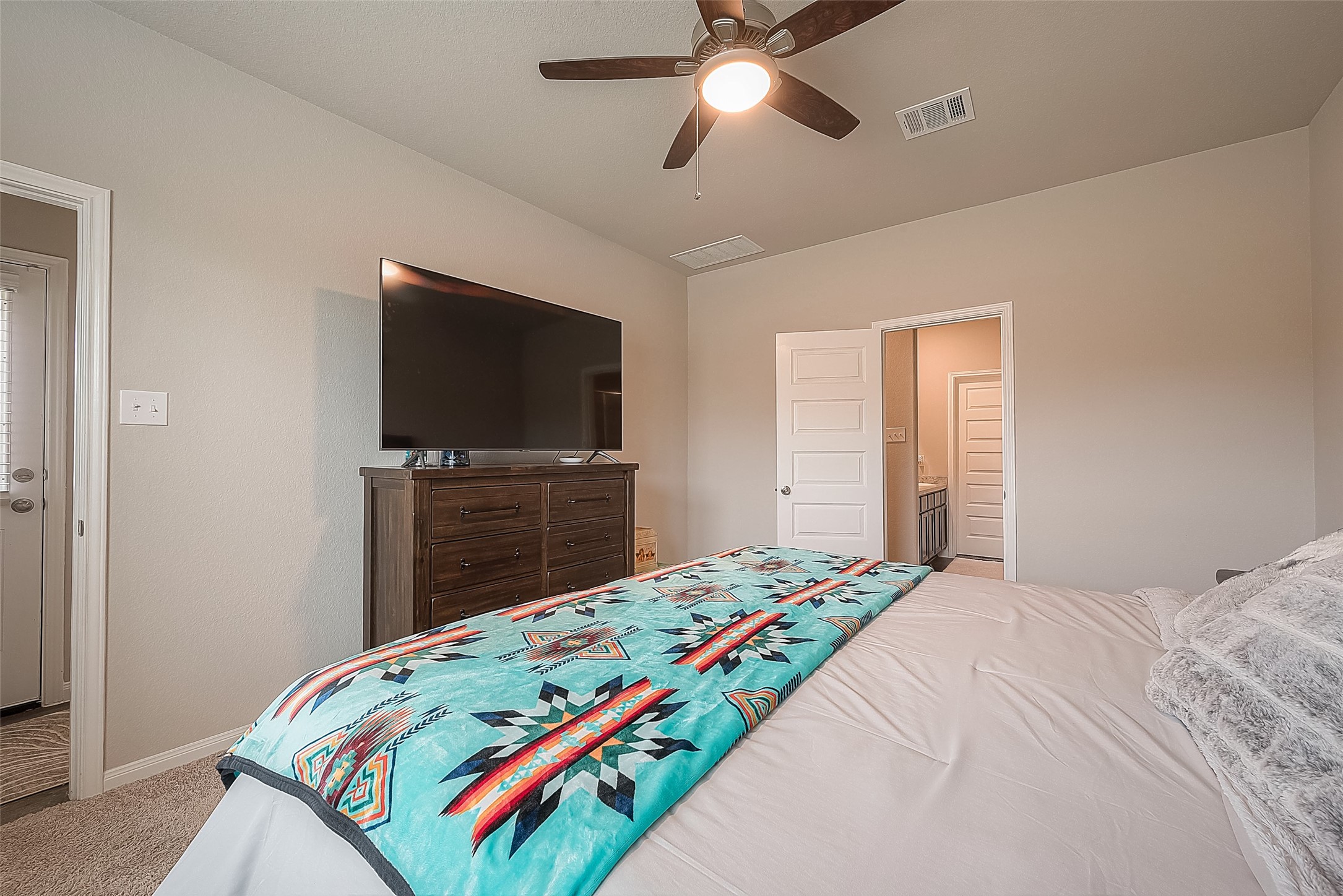 1317 Mount Bassie Trail Conroe, TX 77301 - Photo 25 of 50 a bedroom with a bed and a flat screen tv