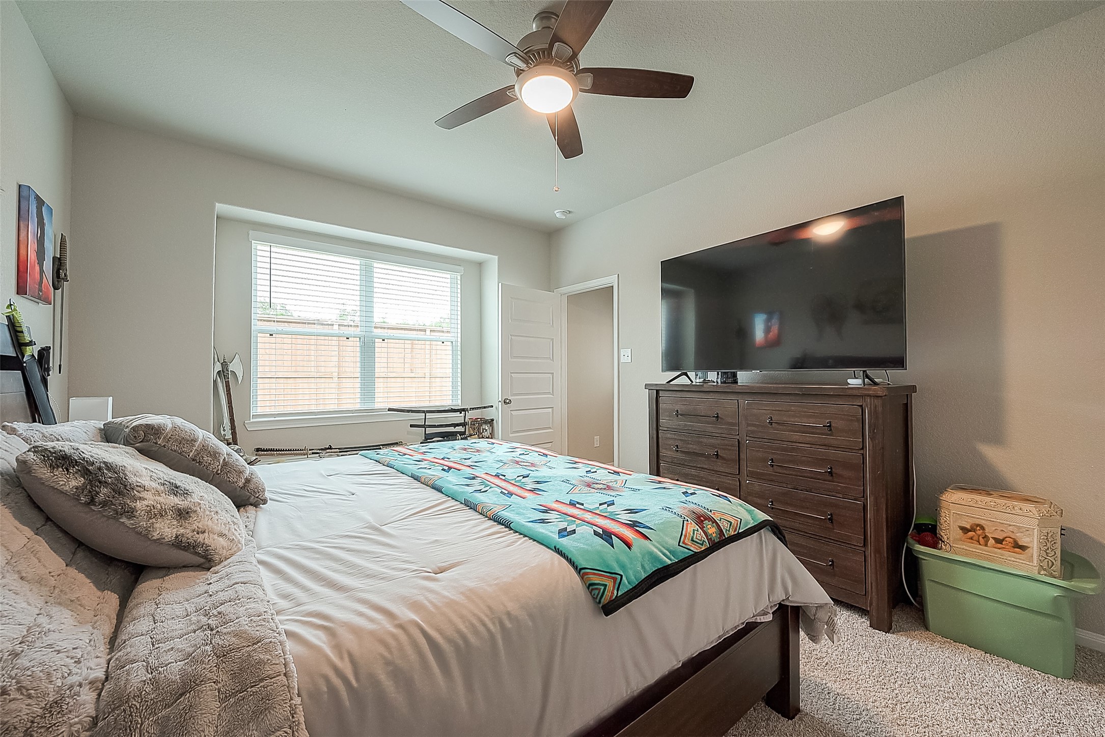 1317 Mount Bassie Trail Conroe, TX 77301 - Photo 27 of 50 a bedroom with a bed and a flat screen tv