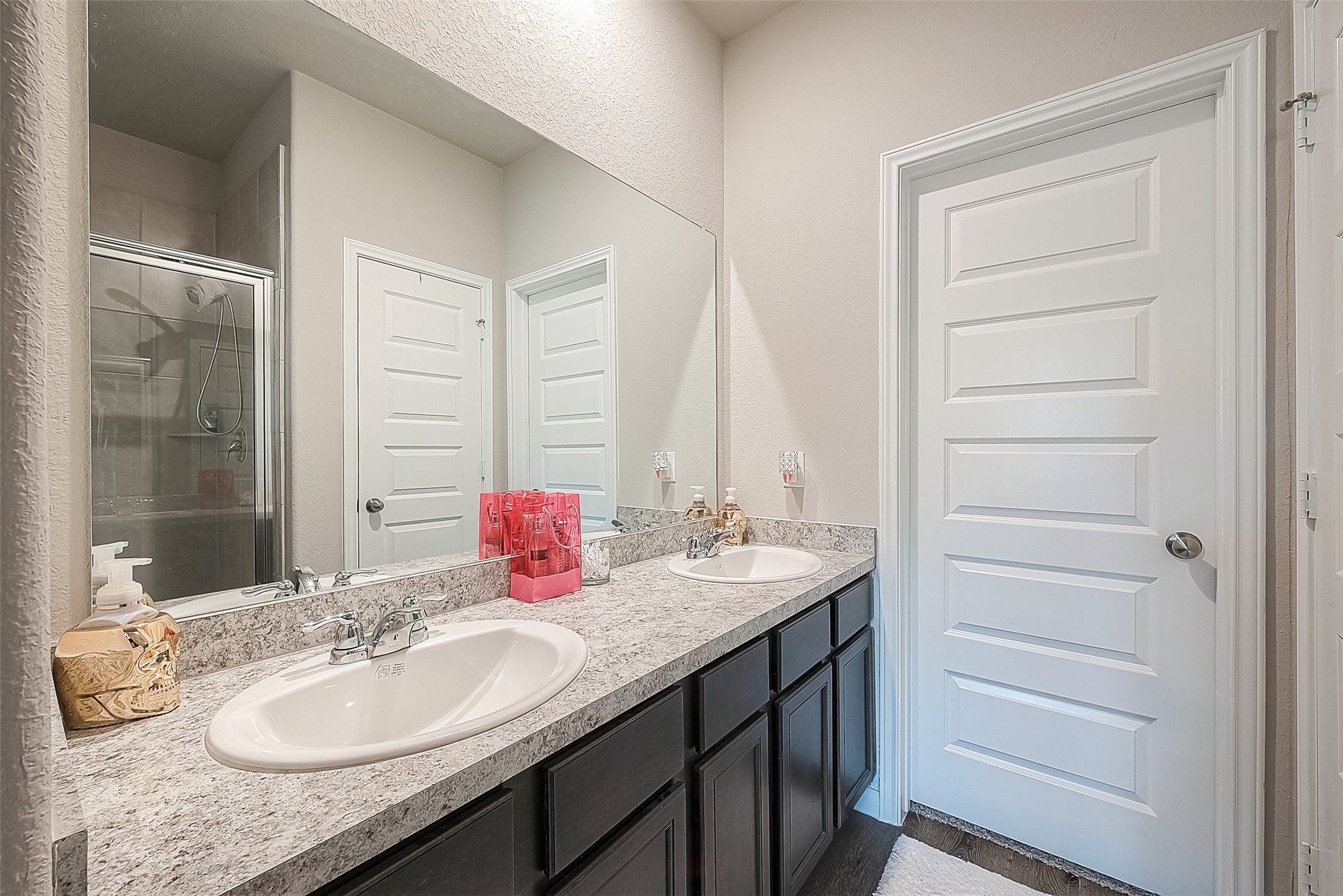 1317 Mount Bassie Trail Conroe, TX 77301 - Photo 29 of 50 a bathroom with a granite countertop sink and a mirror