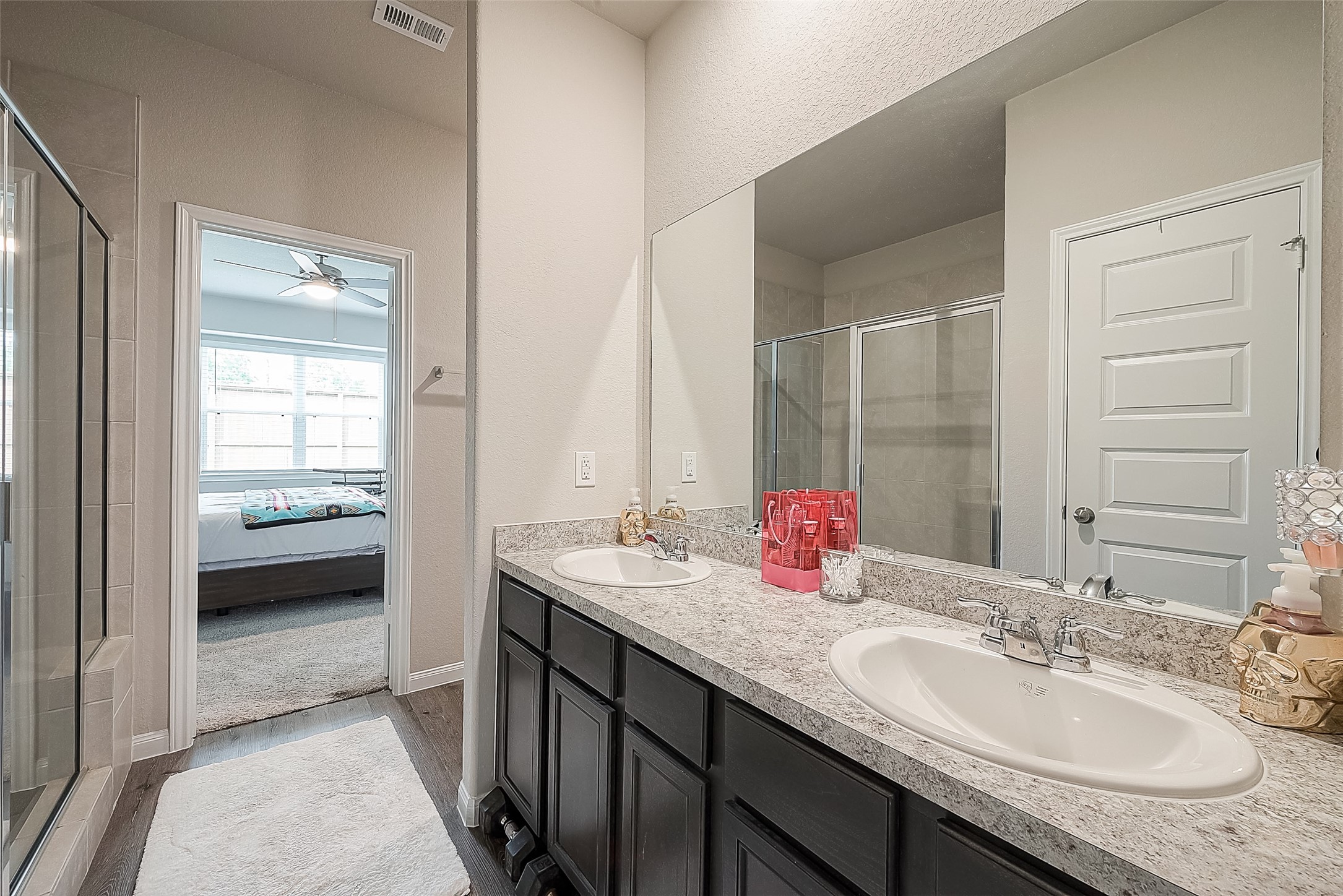 1317 Mount Bassie Trail Conroe, TX 77301 - Photo 30 of 50 a en suite bathroom with a granite countertop sink and a mirror