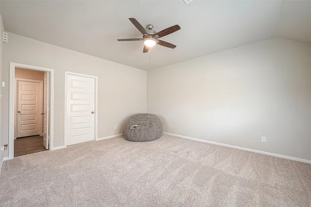 a view of a livingroom with a ceiling fan and window