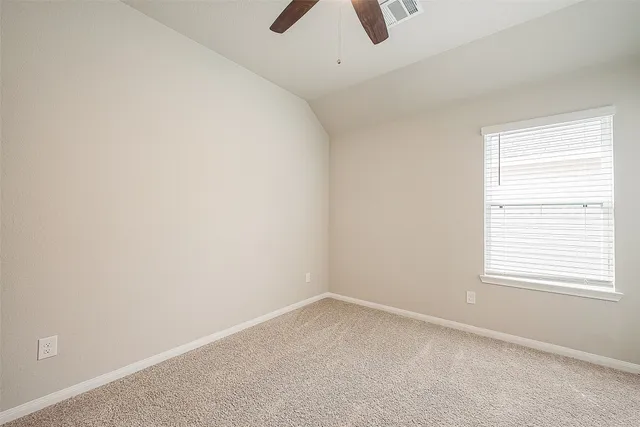 an empty room with a empty space and a ceiling fan