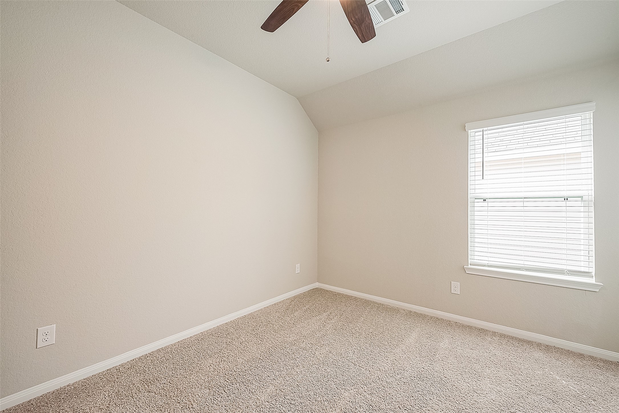 1317 Mount Bassie Trail Conroe, TX 77301 - Photo 35 of 50 an empty room with a window and a ceiling fan
