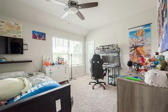 a bedroom with a bed and painting on the wall