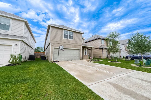 a front view of house with yard and green space