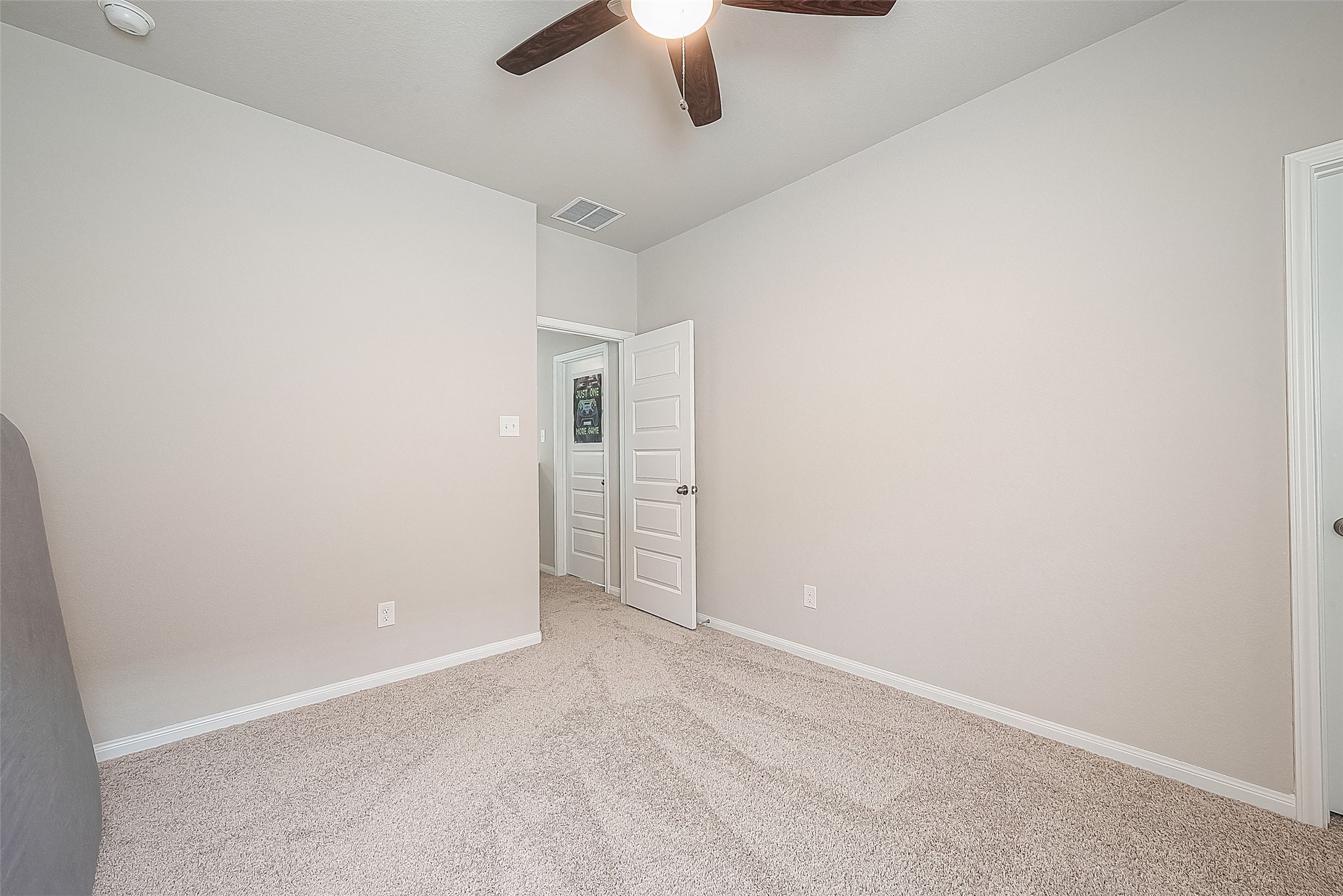 1317 Mount Bassie Trail Conroe, TX 77301 - Photo 42 of 50 an empty room with a empty space and a ceiling fan