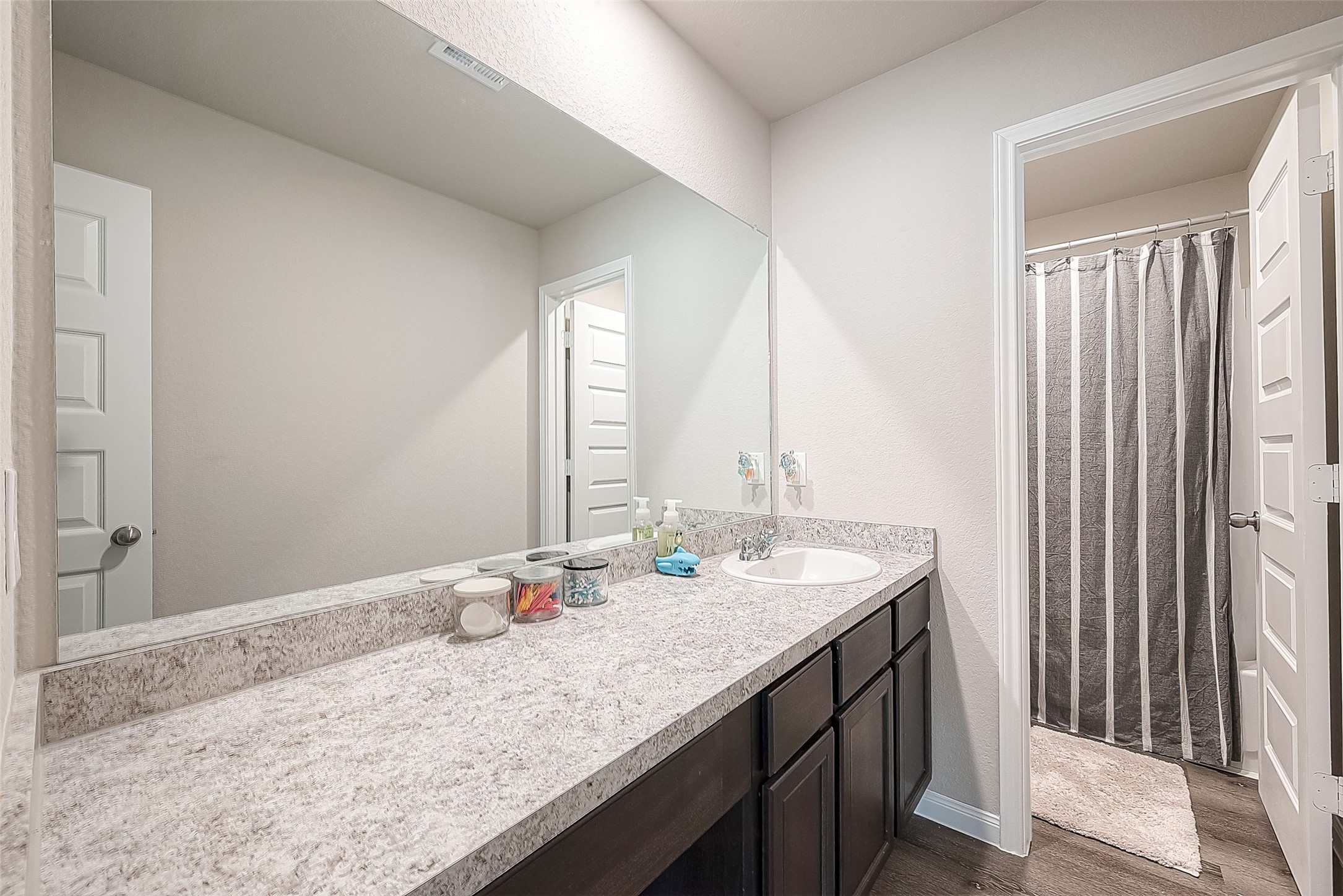 1317 Mount Bassie Trail Conroe, TX 77301 - Photo 43 of 50 a bathroom with a granite countertop sink and a mirror
