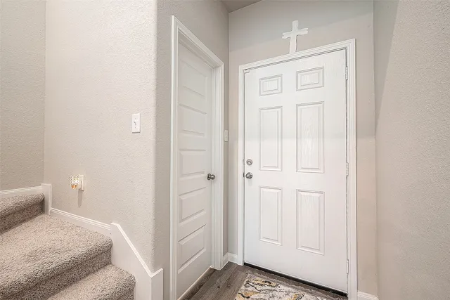 a view of entryway and hall with wooden floor