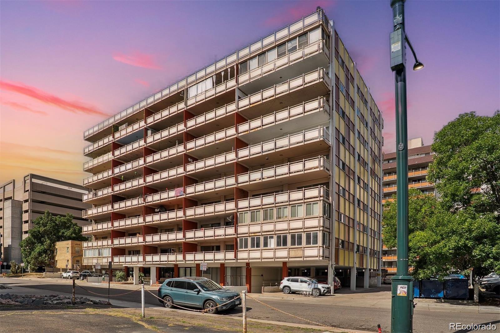 1121 Albion Street, Unit 207 Denver, CO 80220 - Photo 1 of 39 a front view of a building with lot of cars and trees