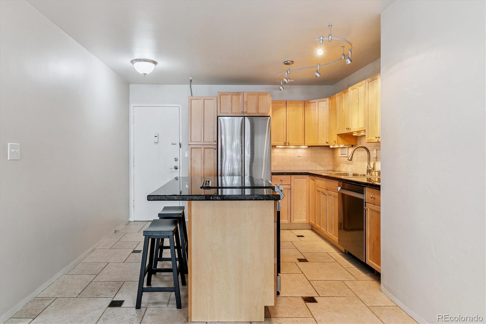 1121 Albion Street, Unit 207 Denver, CO 80220 - Photo 13 of 39 a kitchen with stainless steel appliances granite countertop a refrigerator and a stove top oven