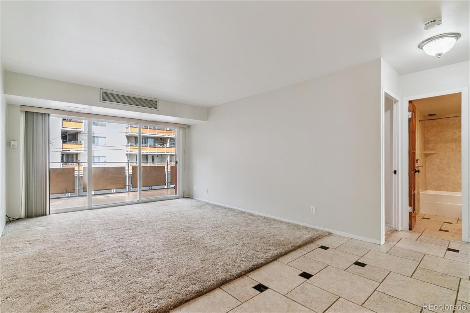 1121 Albion Street, Unit 207 Denver, CO 80220 - Photo 16 of 39 a view of an empty room with a window