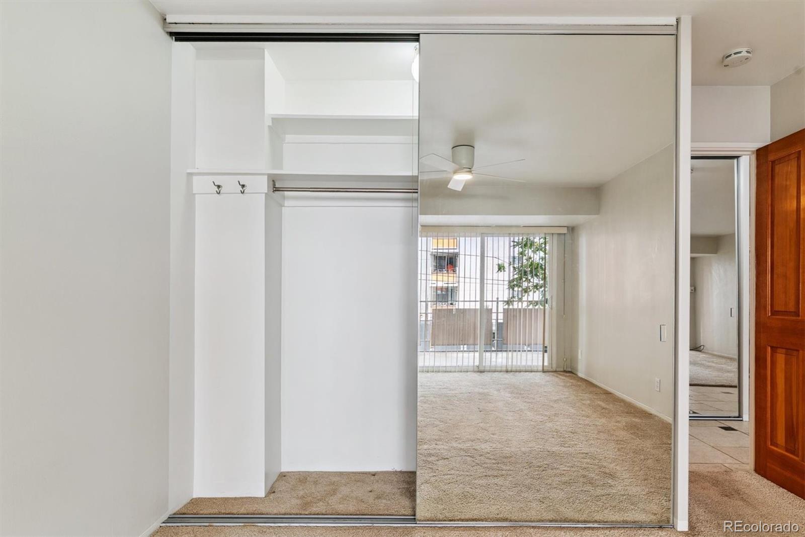 1121 Albion Street, Unit 207 Denver, CO 80220 - Photo 18 of 39 a view of a refrigerator in kitchen and wooden floor