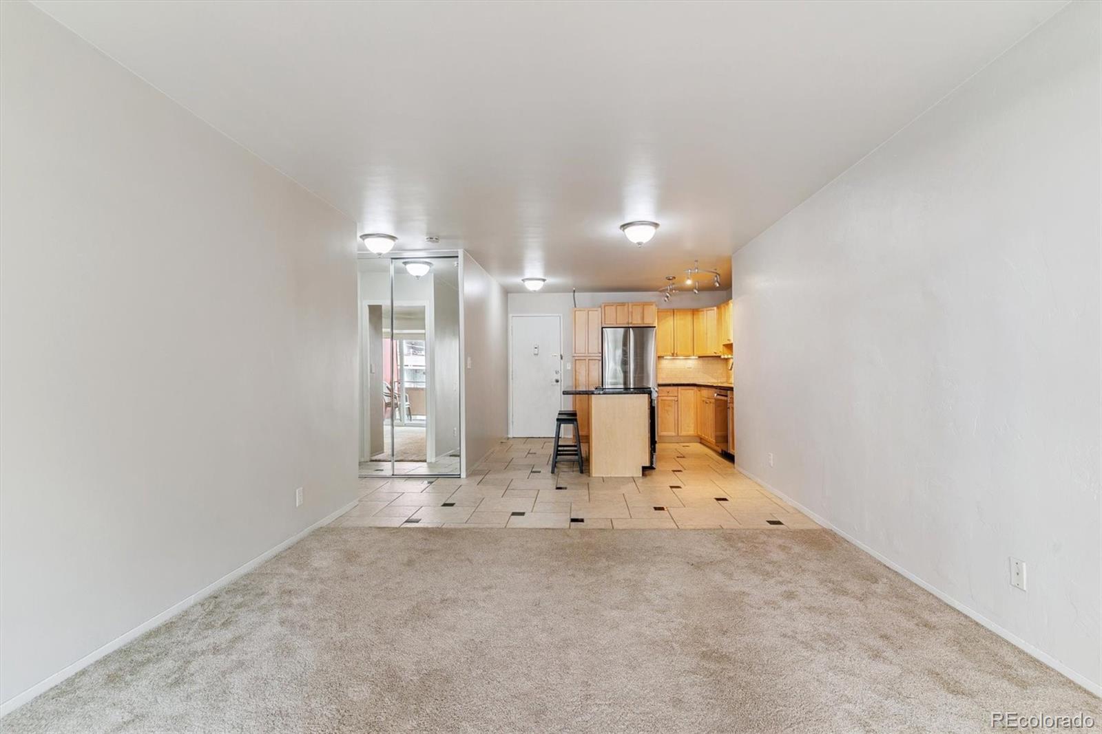 1121 Albion Street, Unit 207 Denver, CO 80220 - Photo 19 of 39 en empty room with kitchen view and appliances