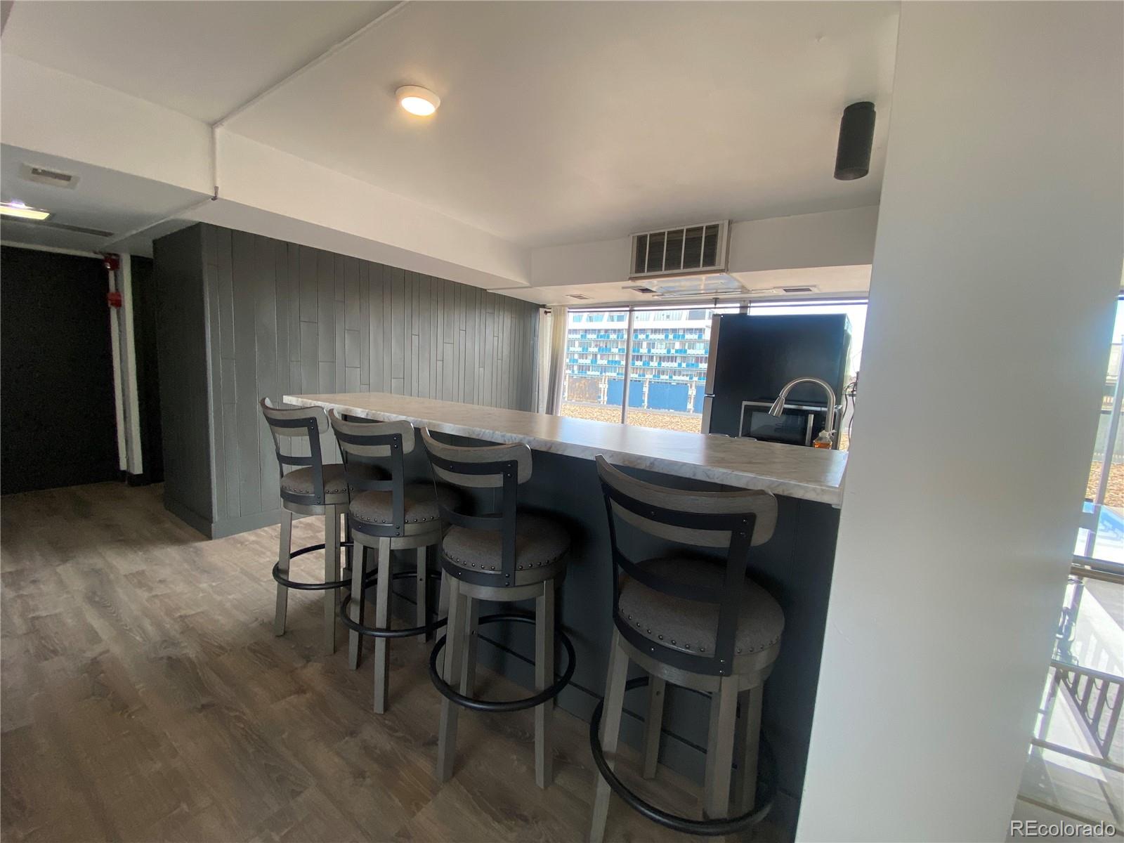 1121 Albion Street, Unit 207 Denver, CO 80220 - Photo 30 of 39 a kitchen with a table chairs and a refrigerator