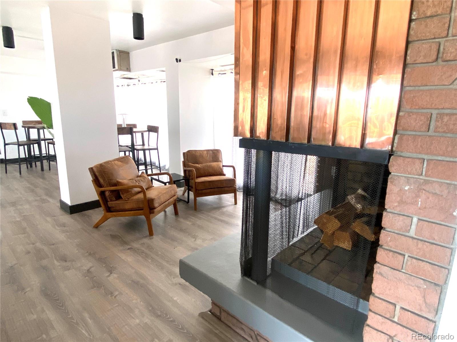 1121 Albion Street, Unit 207 Denver, CO 80220 - Photo 36 of 39 a living room with furniture and a floor to ceiling window