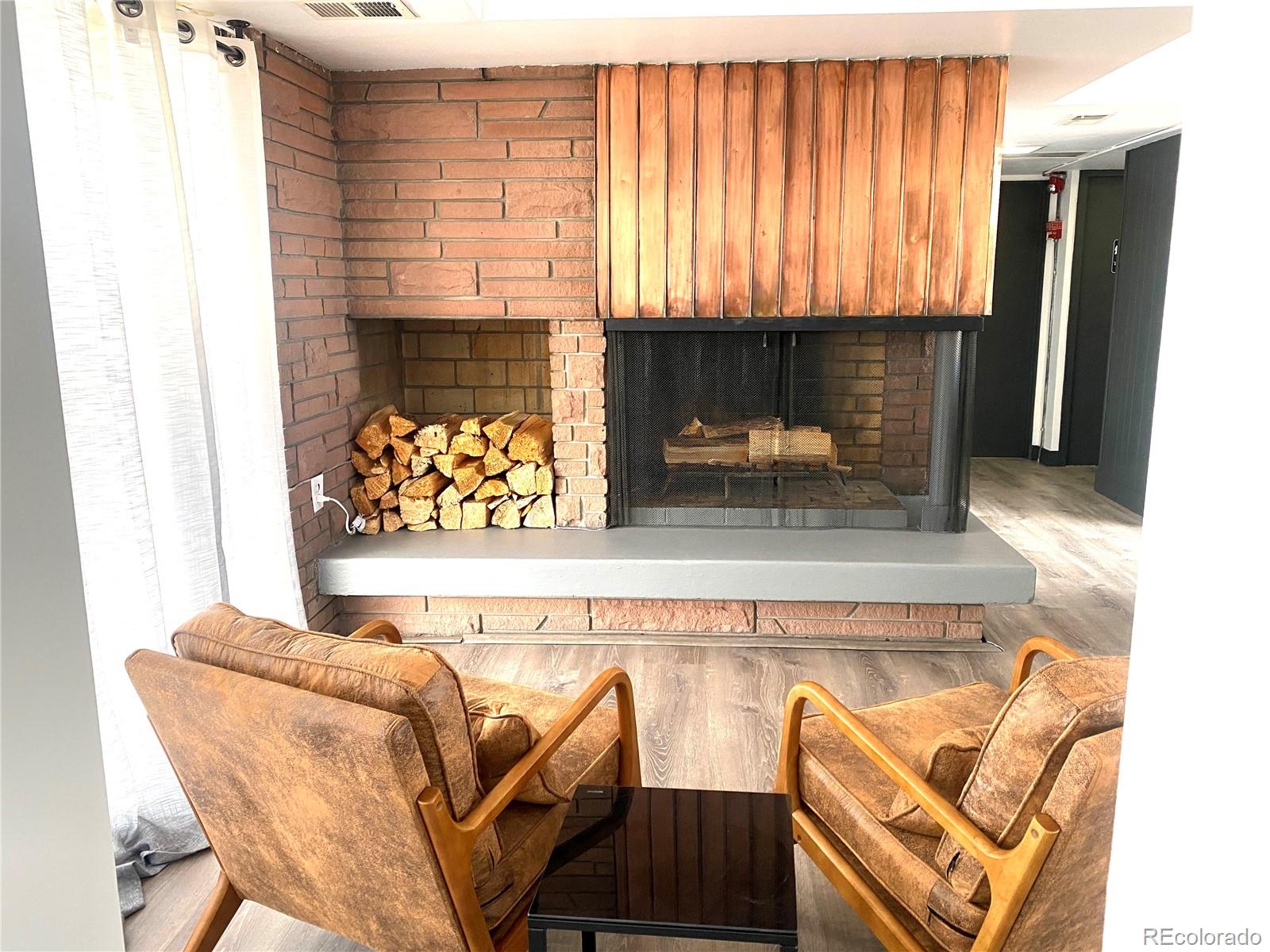 1121 Albion Street, Unit 207 Denver, CO 80220 - Photo 37 of 39 a living room with furniture and a fireplace