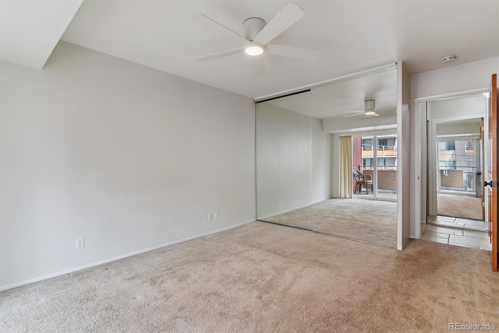 1121 Albion Street, Unit 207 Denver, CO 80220 - Photo 9 of 39 an empty room with fan and entrance