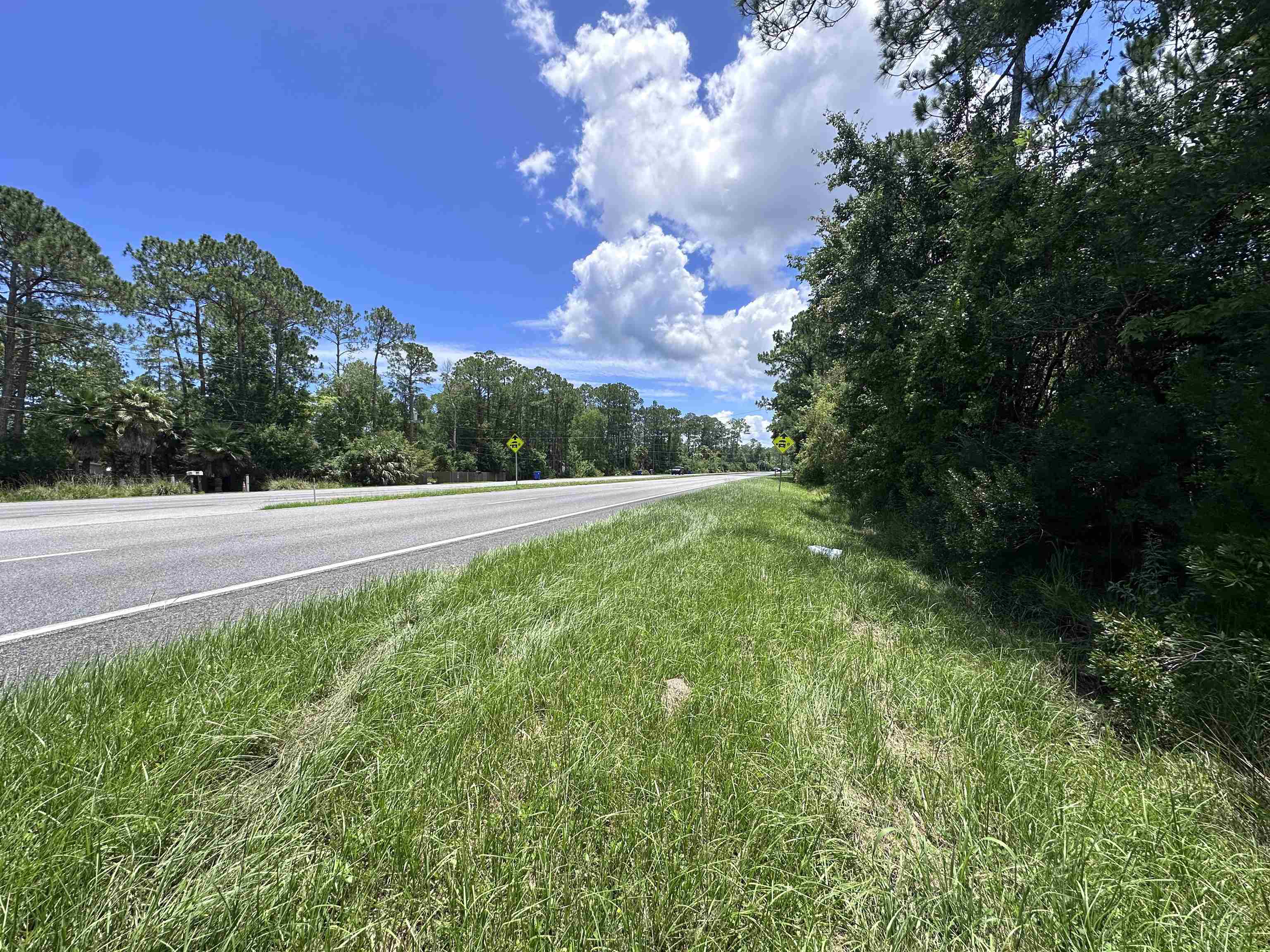7537 Highway 1 St. Augustine, FL 32086 - Photo 3 of 14 a view of a pathway both side of grassy field with shrub