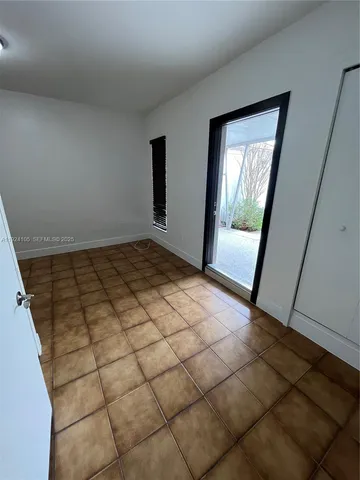 a view of a livingroom with wooden floor and cabinet