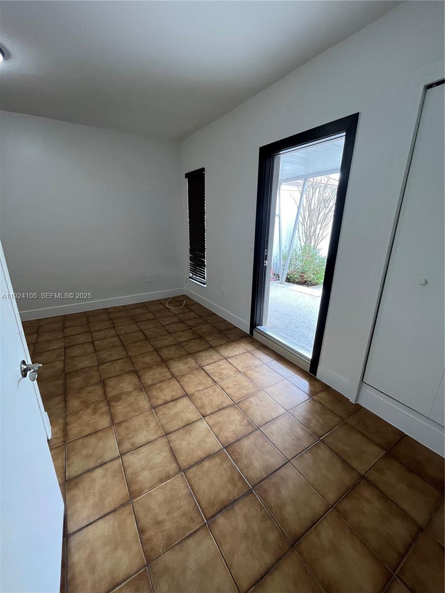 920 Southwest 30th Avenue, Unit 2 Miami, FL 33135 - Photo 3 of 18 a view of a livingroom with wooden floor and cabinet