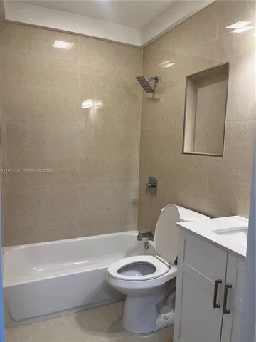 a bathroom with a toilet a sink and bathtub