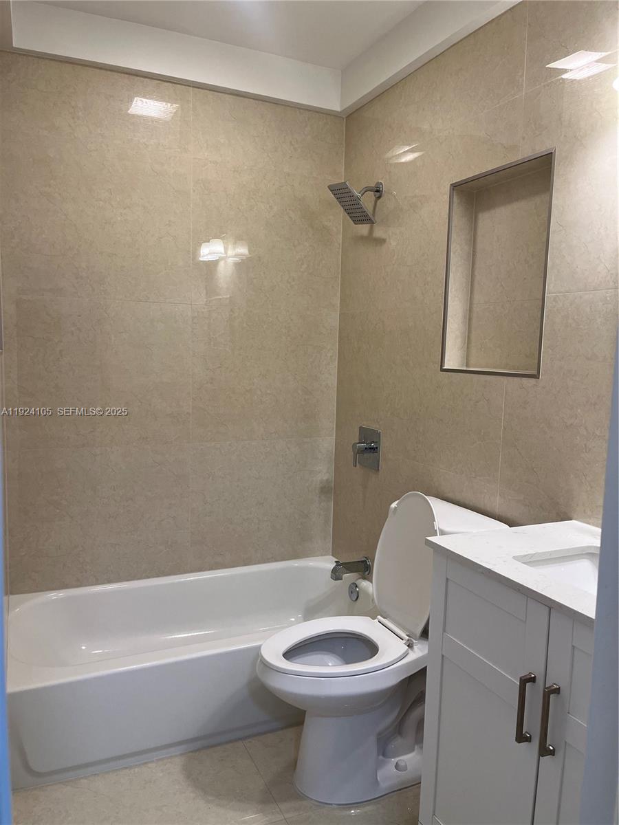 920 Southwest 30th Avenue, Unit 2 Miami, FL 33135 - Photo 10 of 18 a bathroom with a toilet a sink and bathtub