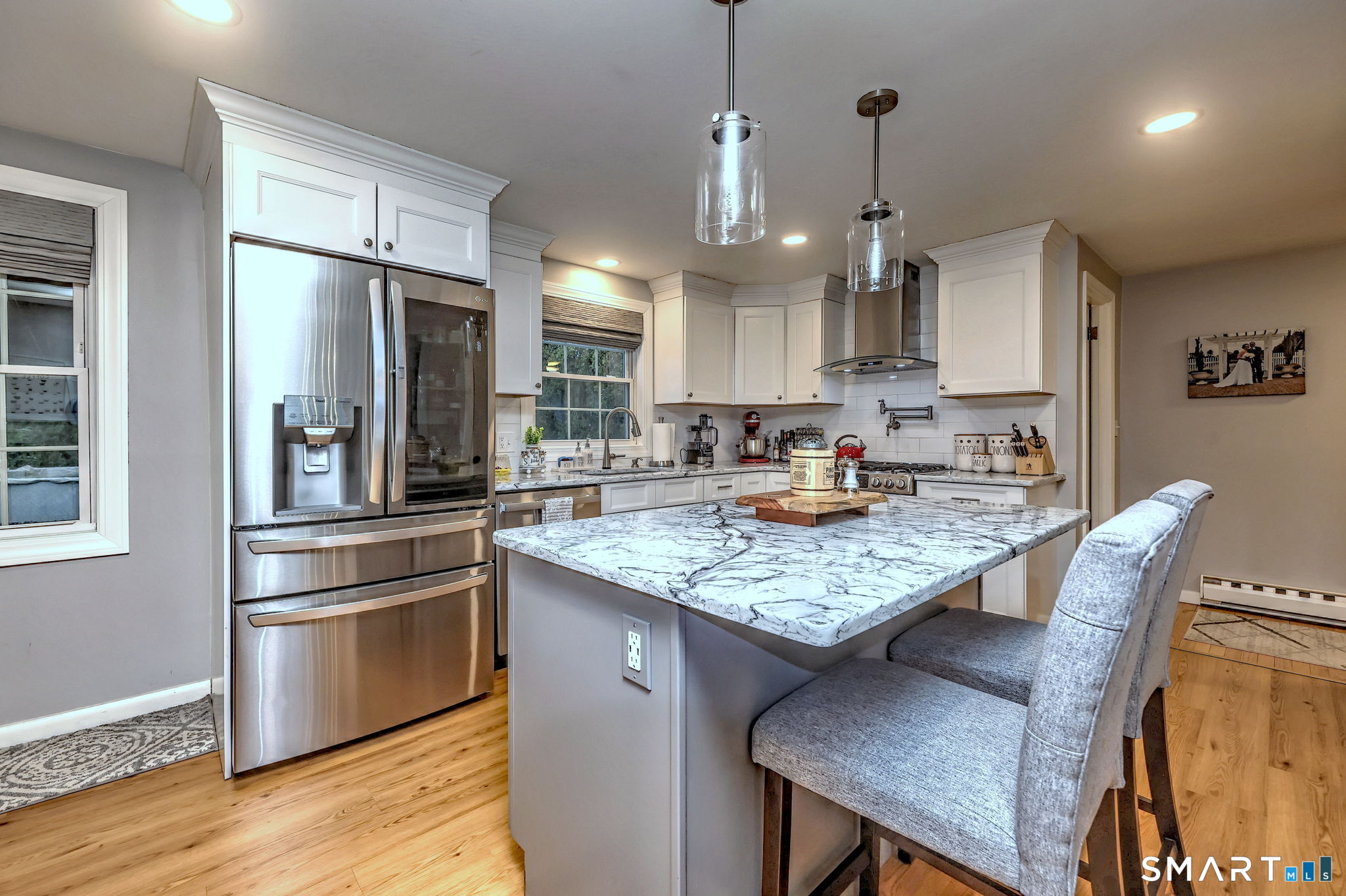 40 Sapphire Street Enfield, CT 06082 - Photo 15 of 41 a kitchen with stainless steel appliances granite countertop a kitchen island a stove a table and chairs in it