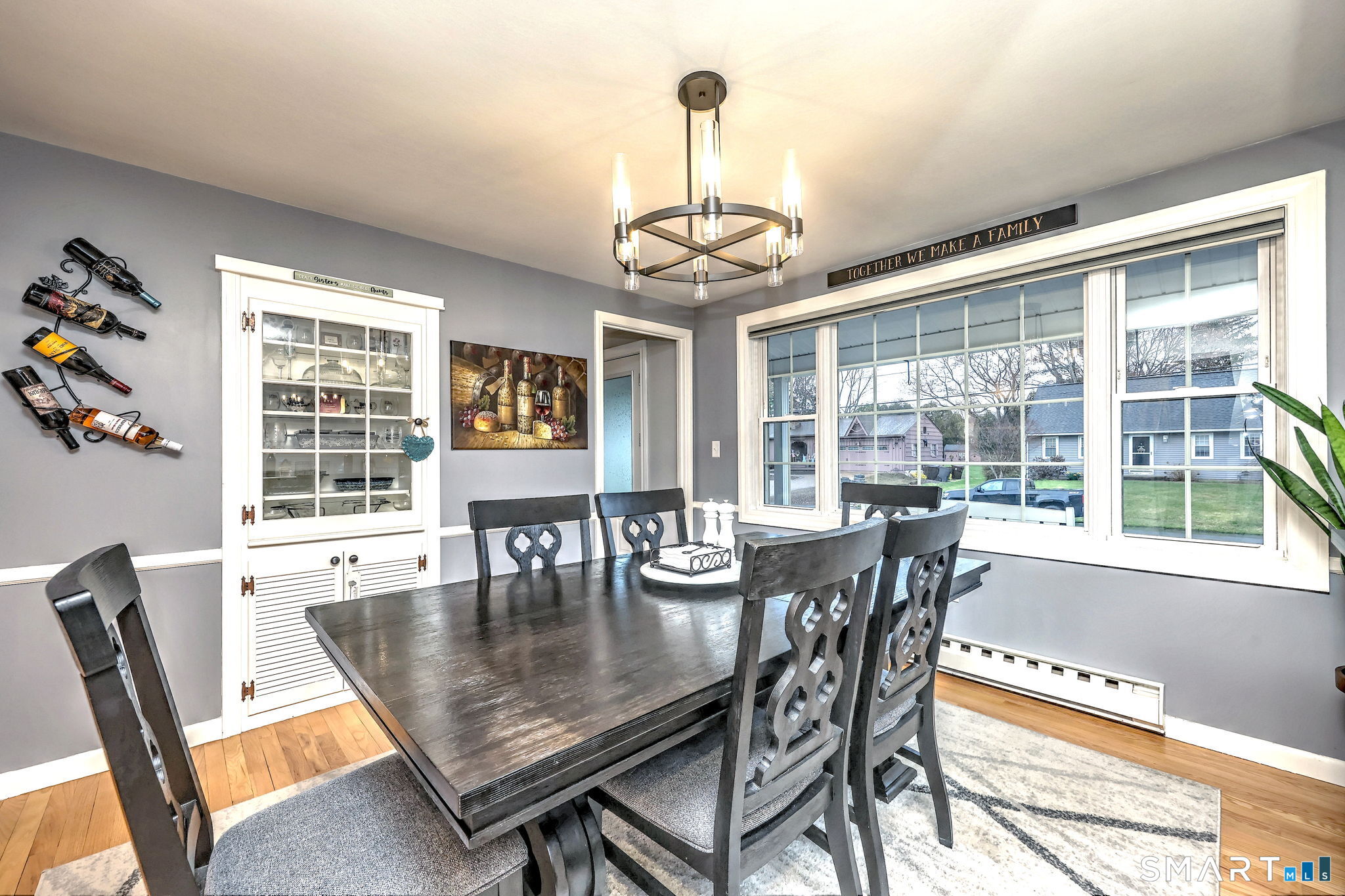 40 Sapphire Street Enfield, CT 06082 - Photo 17 of 41 a dining room with wooden floor a chandelier a wooden table and chairs