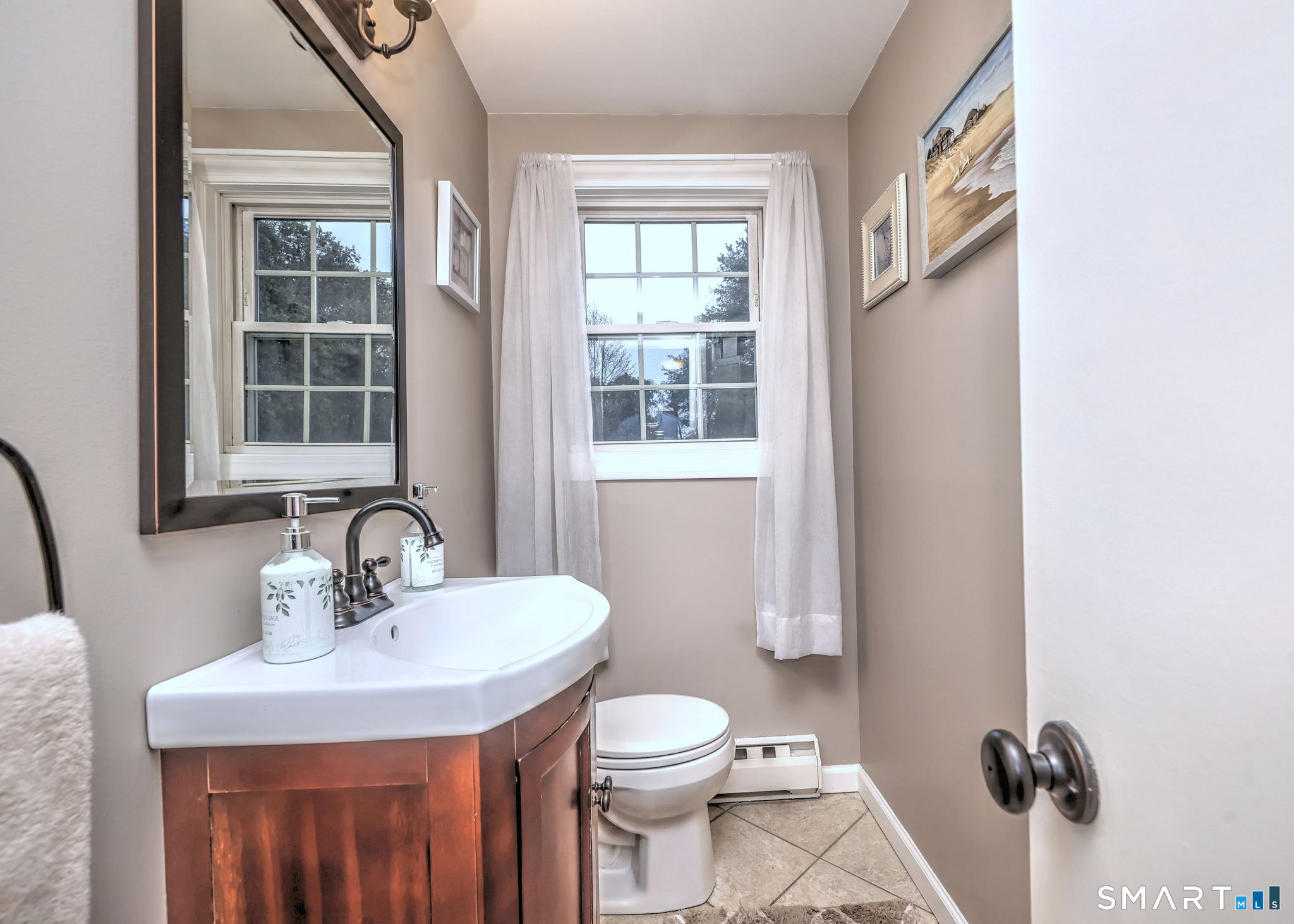 40 Sapphire Street Enfield, CT 06082 - Photo 20 of 41 a bathroom with a toilet a sink a mirror and a window