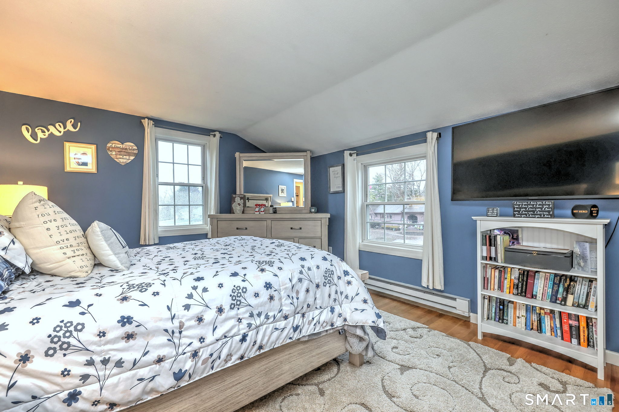40 Sapphire Street Enfield, CT 06082 - Photo 23 of 41 a bedroom with a large bed a flat tv screen and a book shelf