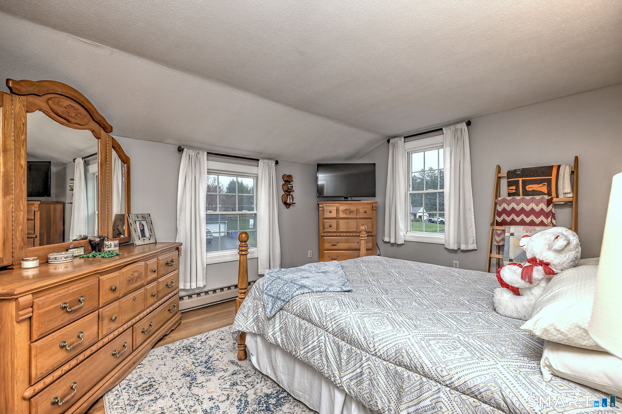 40 Sapphire Street Enfield, CT 06082 - Photo 27 of 41 a bedroom with a bed and wooden floor