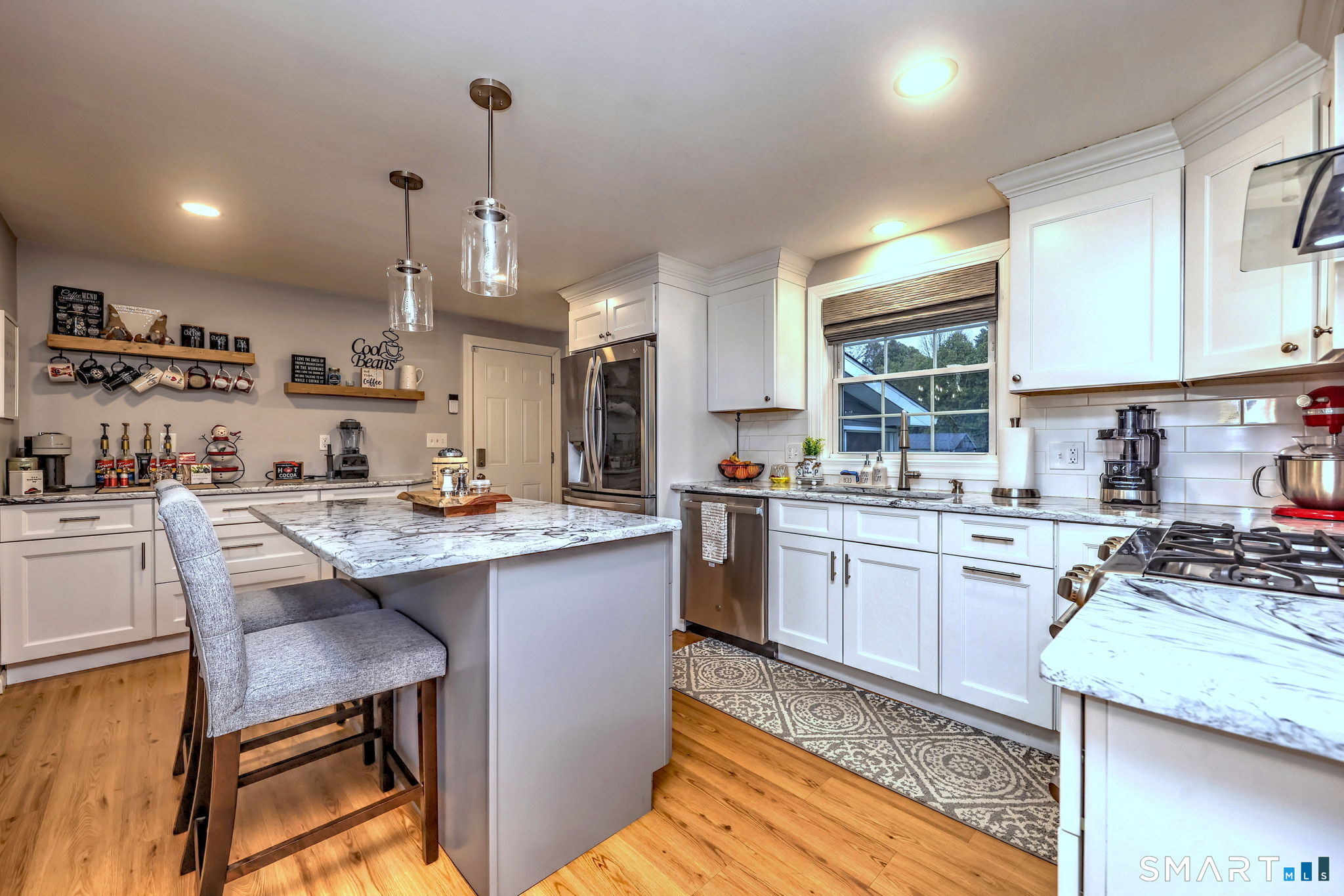 40 Sapphire Street Enfield, CT 06082 - Photo 10 of 41 a kitchen with kitchen island granite countertop wooden cabinets and white appliances