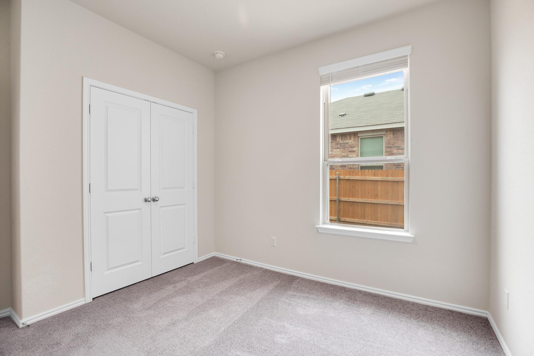 200 Janice Road Taylor, TX 76574 - Photo 22 of 25 A well-lit bedroom provides comfortable living space with a closet and window.