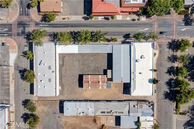 an aerial view of residential houses with outdoor space and lake view