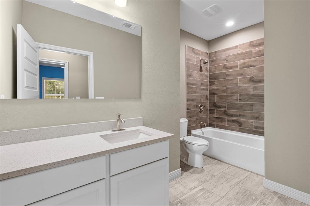 1011 Southeast County Road Corsicana, TX 75109 - Photo 25 of 40 a bathroom with a sink a toilet and shower