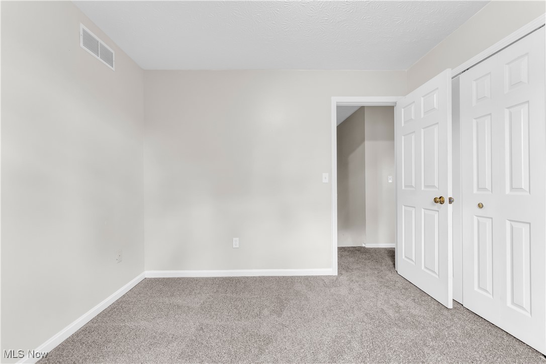 25861 Kennedy Ridge Road North Olmsted, OH 44070 - Photo 19 of 24 Unfurnished bedroom with carpet flooring, baseboards, and a textured ceiling