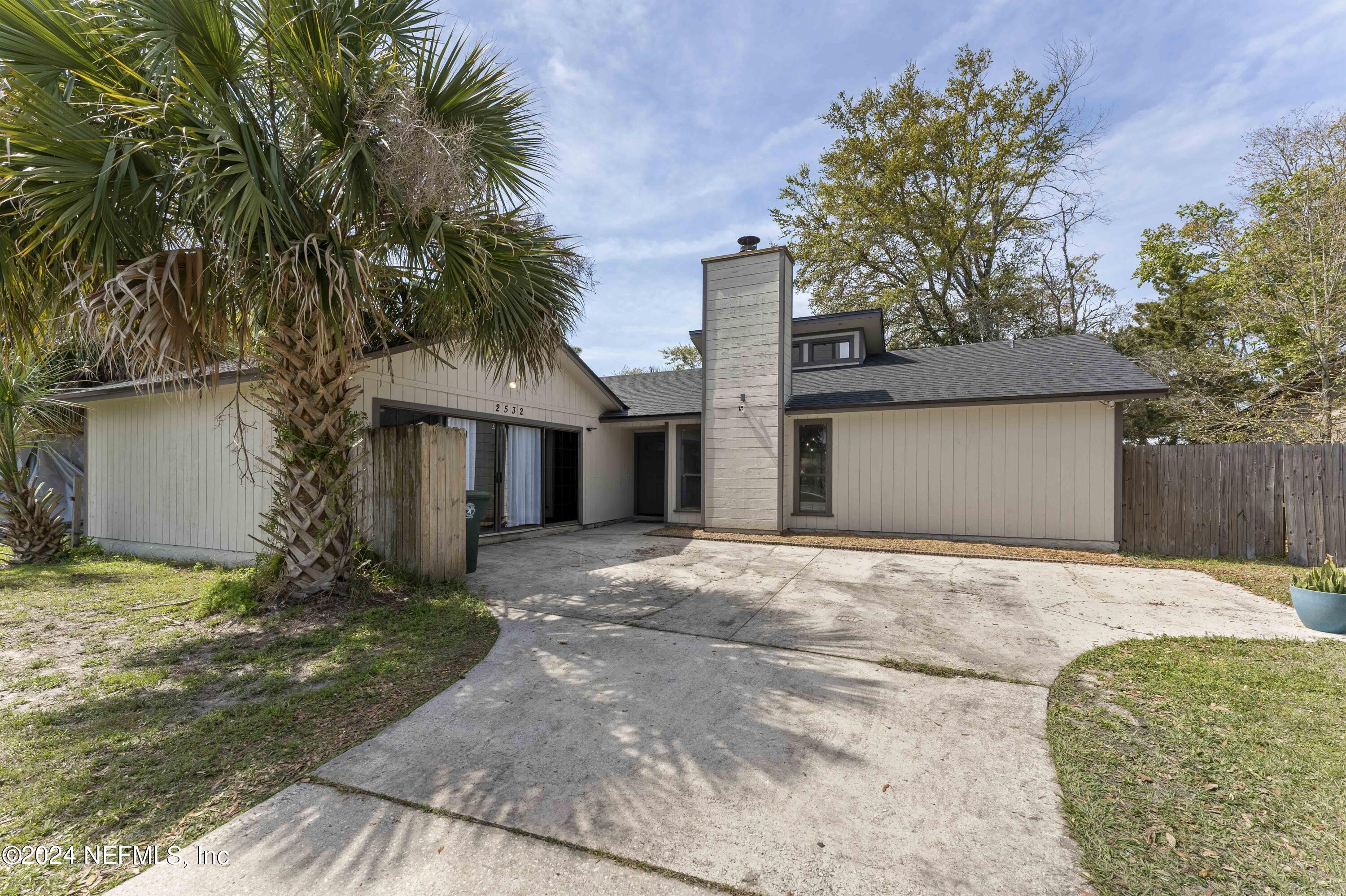 2532 Wattle Tree Road West Jacksonville, FL 32246 - Photo 1 of 25 a front view of a house with garden