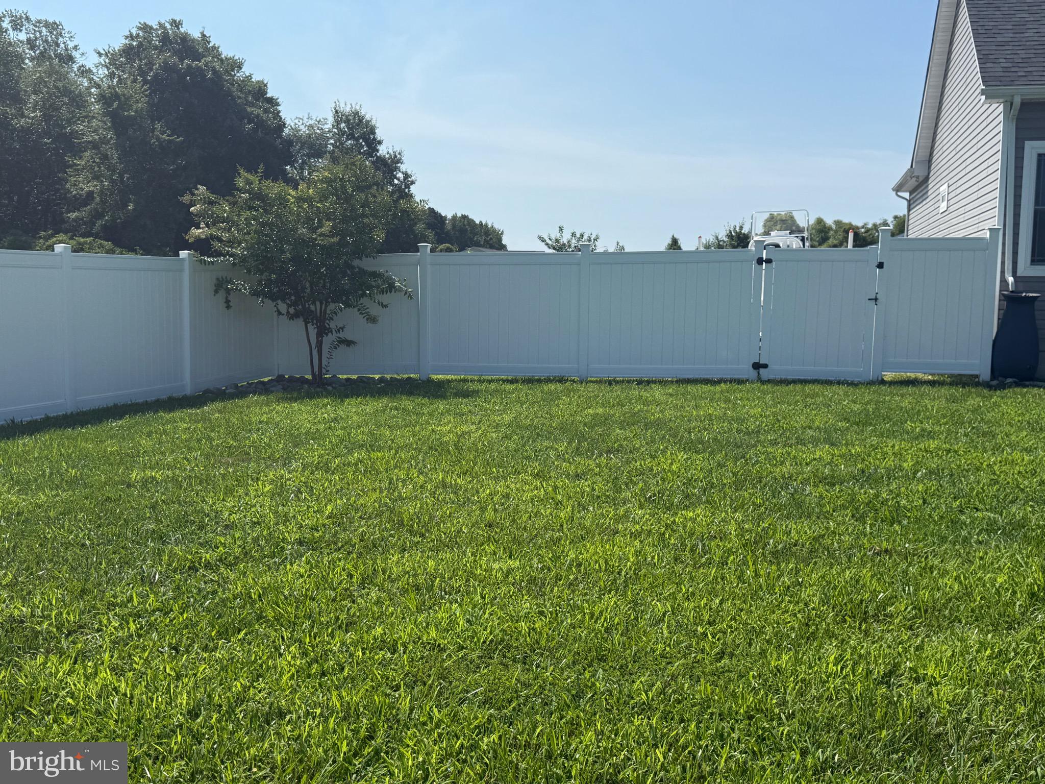 30090 Indian Cottage Road Princess Anne, MD 21853 - Photo 53 of 59 a backyard of a house with lots of green space and wooden fence