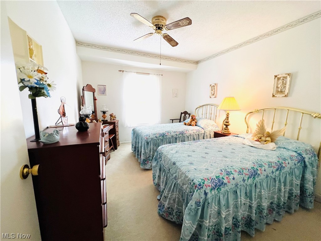 4940 Friar Road, Unit B Stow, OH 44224 - Photo 23 of 33 Carpeted bedroom with ceiling fan and a textured ceiling