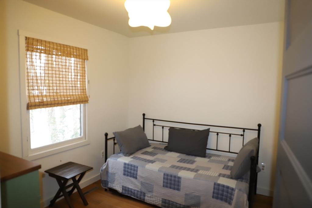 6 Path Road Tolland, MA 01034 - Photo 14 of 36 a bedroom with a bed a table and chair