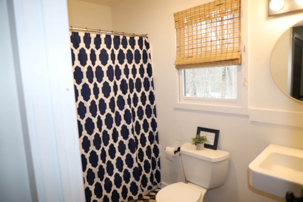 6 Path Road Tolland, MA 01034 - Photo 16 of 36 a bathroom with a toilet and a shower curtain