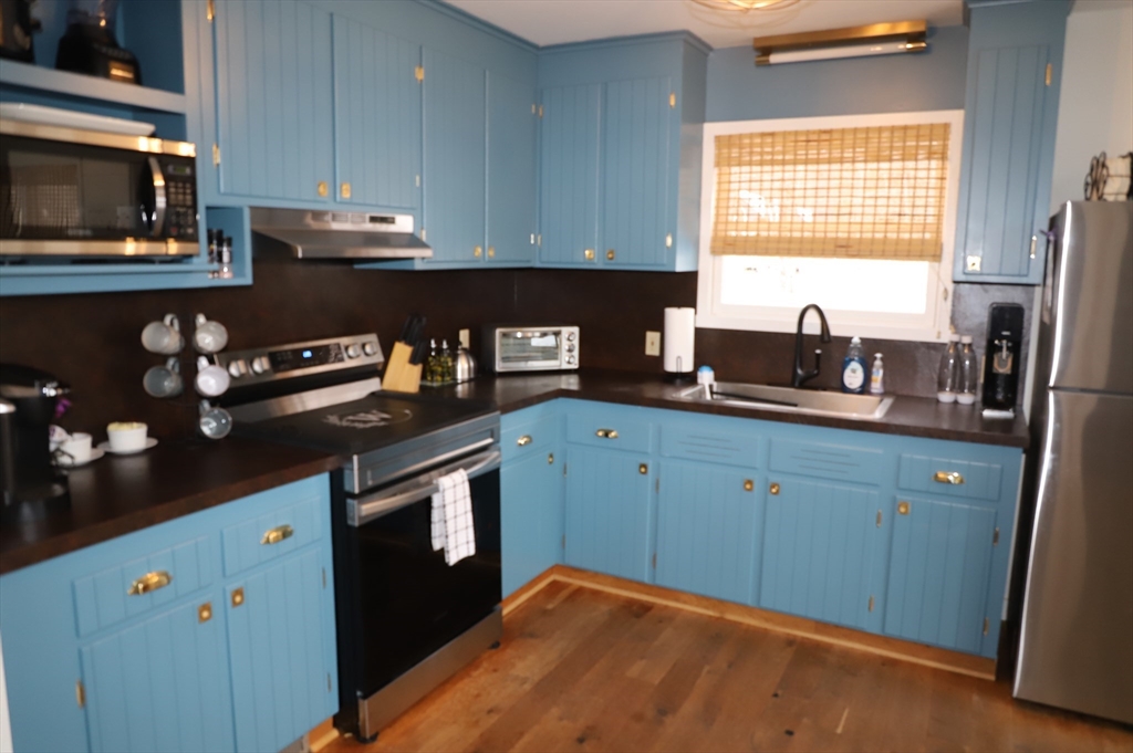 6 Path Road Tolland, MA 01034 - Photo 4 of 36 a kitchen with stainless steel appliances granite countertop a sink a stove and a microwave