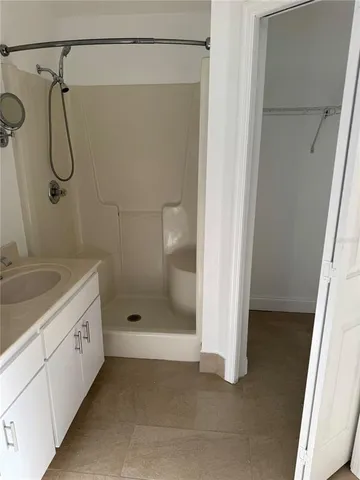 a view of a kitchen with fridge and wooden floor
