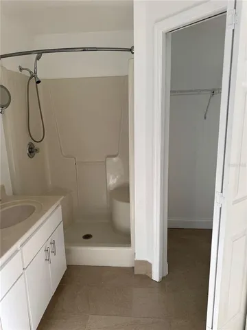 an empty room with windows and cabinet