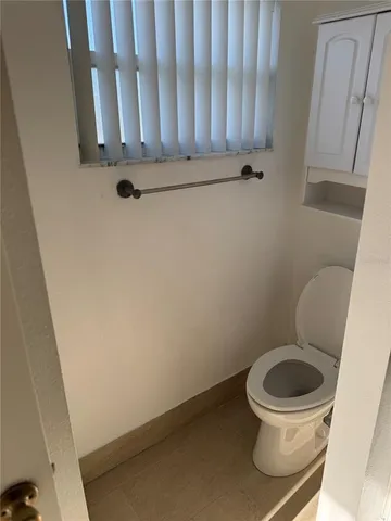 a white toilet sitting next to a bath tub