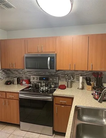a kitchen with a stove and a microwave