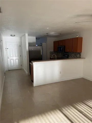 a view of a refrigerator in a kitchen