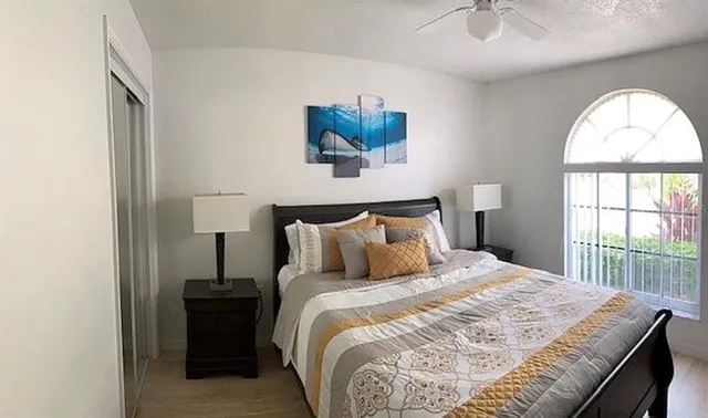 a bedroom with a bed and a large window