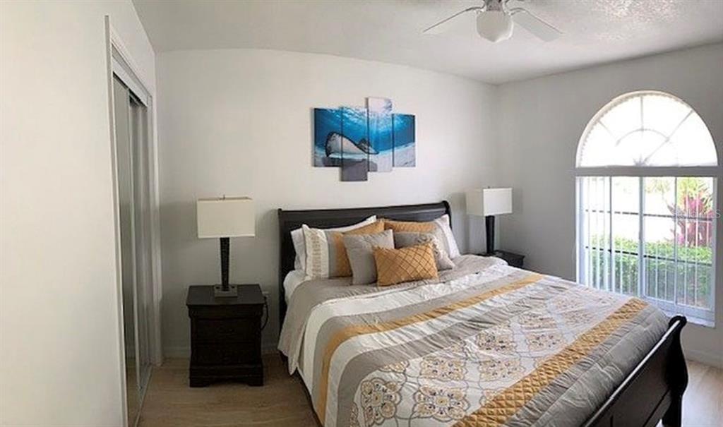 2208 Mystic Ring Loop Kissimmee, FL 34759 - Photo 7 of 12 a bedroom with a bed and a large window